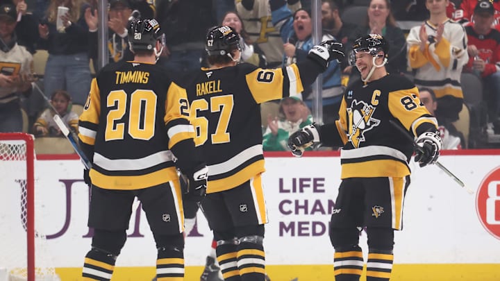 Mar 15, 2025; Pittsburgh, Pennsylvania, USA;  Pittsburgh Penguins right wing Rickard Rakell (67) celebrates his goal with center Sidney Crosby (87) against the New Jersey Devils during the second period at PPG Paints Arena. Mandatory Credit: Charles LeClaire-Imagn Images