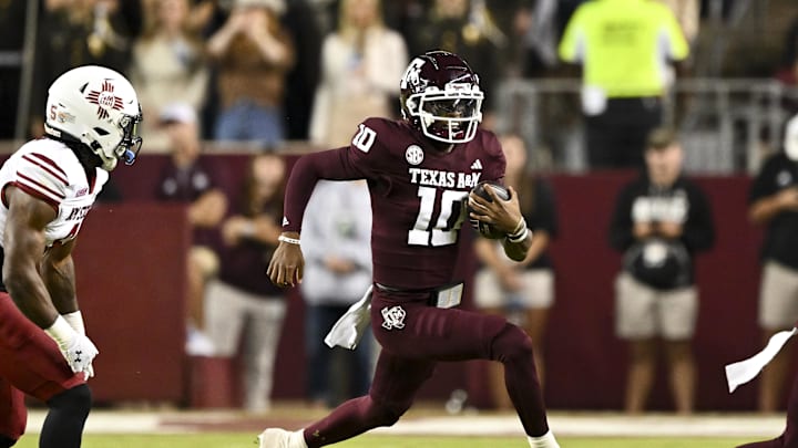 Nov 16, 2024; College Station, Texas, USA; Texas A&M Aggies quarterback Marcel Reed (10) runs the ball during the first half against the New Mexico State Aggies at Kyle Field. Mandatory Credit: Maria Lysaker-Imagn Images 