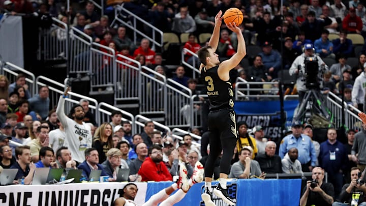 Mar 23, 2024; Pittsburgh, PA, USA; Oakland Golden Grizzlies guard Jack Gohlke (3) shoots the ball against North Carolina State Wolfpack guard Casey Morsell (14) during the second half in the second round of the 2024 NCAA Tournament at PPG Paints Arena. Mandatory Credit: Charles LeClaire-Imagn Images