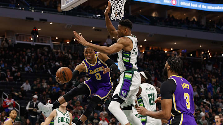 Nov 17, 2021; Milwaukee, Wisconsin, USA; Los Angeles Lakers guard Russell Westbrook (0) passes the ball around Milwaukee Bucks forward Giannis Antetokounmpo (34) during the first quarter at Fiserv Forum. Mandatory Credit: Jeff Hanisch-Imagn Images Nov 17, 2021; Milwaukee, Wisconsin, USA; Los Angeles Lakers guard Russell Westbrook (0) passes the ball around Milwaukee Bucks forward Giannis Antetokounmpo (34) during the first quarter at Fiserv Forum. Mandatory Credit: Jeff Hanisch-Imagn Images