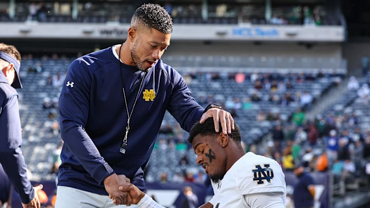 Oct 26, 2024; East Rutherford, New Jersey, USA; Notre Dame Fighting Irish head coach Marcus Freeman greets players before the game against the Navy Midshipmen at MetLife Stadium.