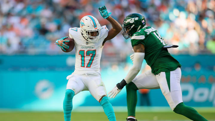Dec 17, 2023; Miami Gardens, Florida, USA; Miami Dolphins wide receiver Cedrick Wilson Jr. (11) breaks a tackle from New York Jets linebacker Jermaine Johnson (11) during the fourth quarter at Hard Rock Stadium. Mandatory Credit: Sam Navarro-Imagn Images Dec 17, 2023; Miami Gardens, Florida, USA; Miami Dolphins wide receiver Cedrick Wilson Jr. (11) breaks a tackle from New York Jets linebacker Jermaine Johnson (11) during the fourth quarter at Hard Rock Stadium. Mandatory Credit: Sam Navarro-Imagn Images