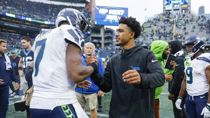 Sep 24, 2023; Seattle, Washington, USA; Seattle Seahawks quarterback Geno Smith (7) shakes hands with Carolina Panthers quarterback Bryce Young (9, right) following a 37-27 Seattle victory at Lumen Field.