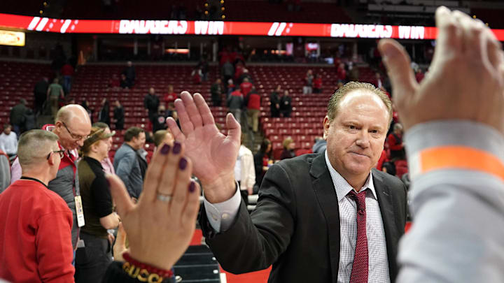 Jan 17, 2023; Madison, Wisconsin, USA;  Wisconsin Badgers head coach Greg Gard high fives fans following the Wisconsin Badgers 63-60 win over the Penn State Nittany Lions at the Kohl Center. 