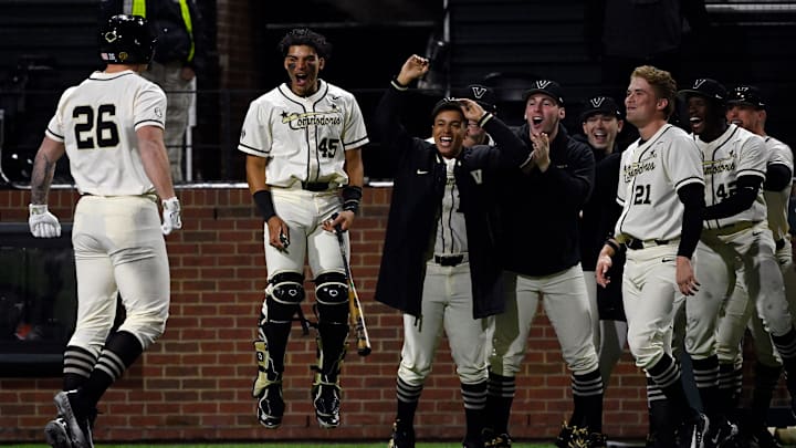 Vanderbilt pinch hitter Braden Holcomb (26) celebrates with teammates after hitting a two-run homer