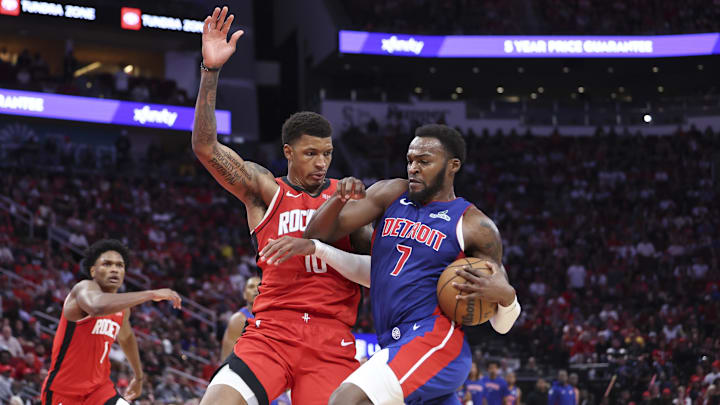 Oct 24, 2025; Houston, Texas, USA; Detroit Pistons forward Paul Reed (7) drives with the ball as Houston Rockets forward Jabari Smith Jr. (10) defends during the fourth quarter at Toyota Center. Mandatory Credit: Troy Taormina-Imagn Images
