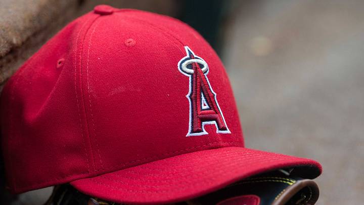 An Angels baseball hat and glove and logo before the game between the Texas Rangers and the Los Angeles Angels at Globe Life Park in Arlington on July 3, 2015. An Angels baseball hat and glove and logo before the game between the Texas Rangers and the Los Angeles Angels at Globe Life Park in Arlington on July 3, 2015.