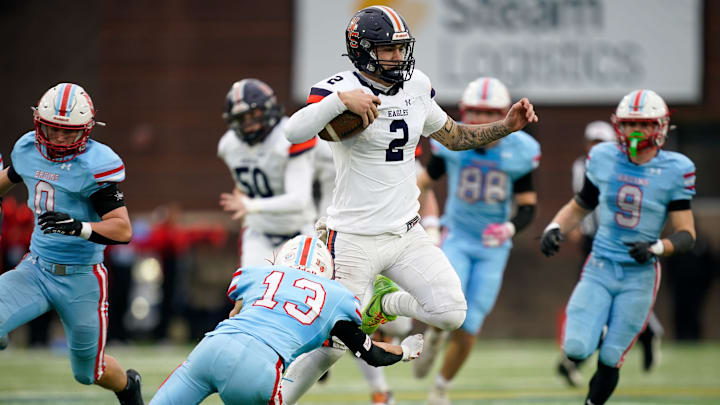 Nashville Christian's Jared Curtis (2) escapes from the grip of USJ’s Jacob Snider (13) during the second quarter of the Division II-A championship at Finley Stadium in Chattanooga, Tenn., Thursday, Dec. 4, 2025. Nashville Christian's Jared Curtis (2) escapes from the grip of USJ’s Jacob Snider (13) during the second quarter of the Division II-A championship at Finley Stadium in Chattanooga, Tenn., Thursday, Dec. 4, 2025.