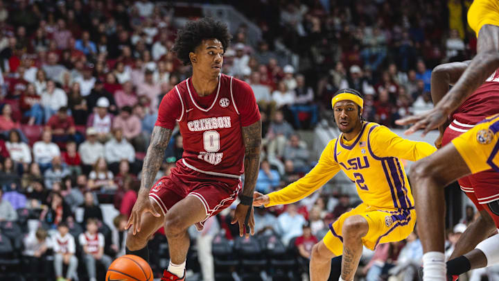 Jan 25, 2025; Tuscaloosa, Alabama, USA; Alabama Crimson Tide guard Labaron Philon (0) controls the ball against LSU Tigers guard Mike Williams III (2) during the first half at Coleman Coliseum. Mandatory Credit: Will McLelland-Imagn Images