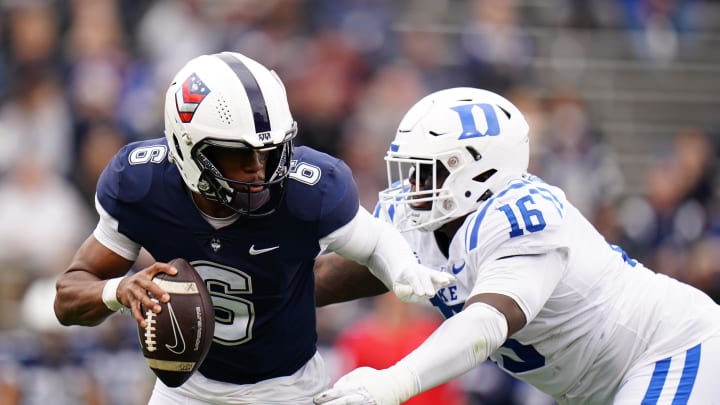Sep 23, 2023; East Hartford, Connecticut, USA; UConn Huskies quarterback Ta'Quan Roberson (6) is sacked by Duke Blue Devils defensive tackle Aeneas Peebles (16) in the second quarter at Rentschler Field at Pratt & Whitney Stadium. Mandatory Credit: David Butler II-USA TODAY Sports