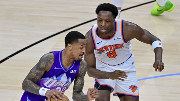 Nov 23, 2024; Salt Lake City, Utah, USA; Utah Jazz forward/center John Collins (20) dribbles the ball against New York Knicks forward/guard OG Anunoby (8) during the second half at the Delta Center. Mandatory Credit: Christopher Creveling-Imagn Images