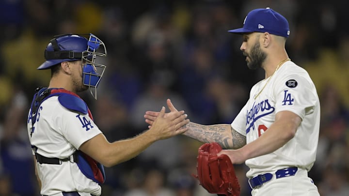 Apr 16, 2025; Los Angeles, California, USA;  Los Angeles Dodgers catcher Austin Barnes (15) shakes hands with relief pitcher Tanner Scott (66) after earning a save against the Colorado Rockies at Dodger Stadium. Mandatory Credit: Jayne Kamin-Oncea-Imagn Images
