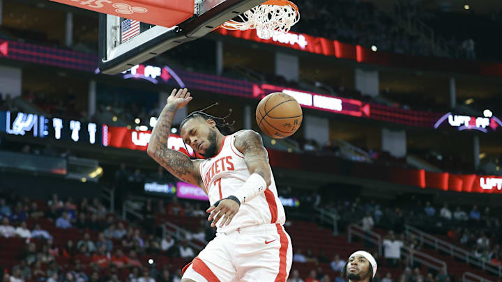 Nov 6, 2024; Houston, Texas, USA; Houston Rockets forward Cam Whitmore (7) dunks the ball as San Antonio Spurs guard David Duke Jr. (7) looks on during the fourth quarter at Toyota Center. Mandatory Credit: Troy Taormina-Imagn Images