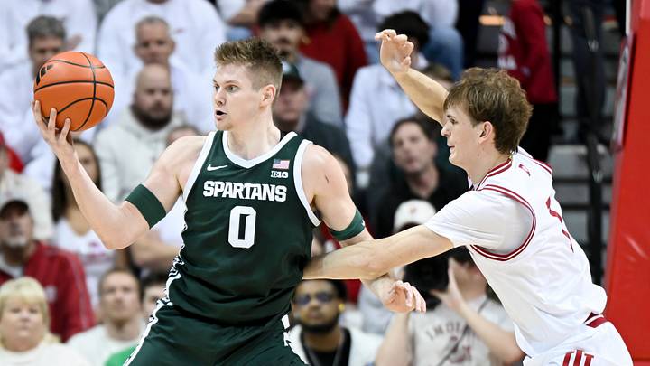 Mar 1, 2026; Bloomington, Indiana, USA; Michigan State Spartans forward Jaxon Kohler (0) dribbles against Indiana Hoosiers forward Reed Bailey (1) during the first half at Simon Skjodt Assembly Hall. Mandatory Credit: Robert Goddin-Imagn Images