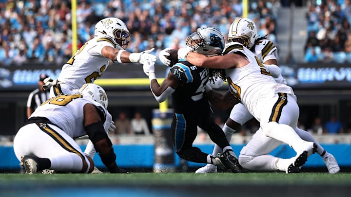 New Orleans Saints defenders bring down Carolina Panthers running back Rico Dowdle (5) on Nov. 10, 2025.
