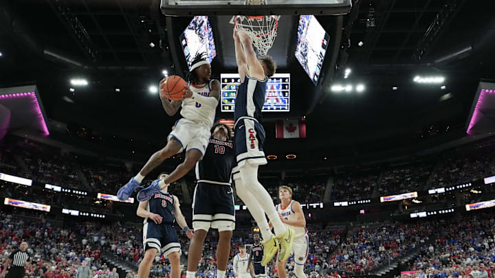 Nov 3, 2025; Las Vegas, NV, USA; Florida Gators guard Boogie Fland (0) makes a pass around Arizona Wildcats center Motiejus Krivas (13) during the second half of the Hall of Fame Series game at T-Mobile Arena. Mandatory Credit: Candice Ward-Imagn Images