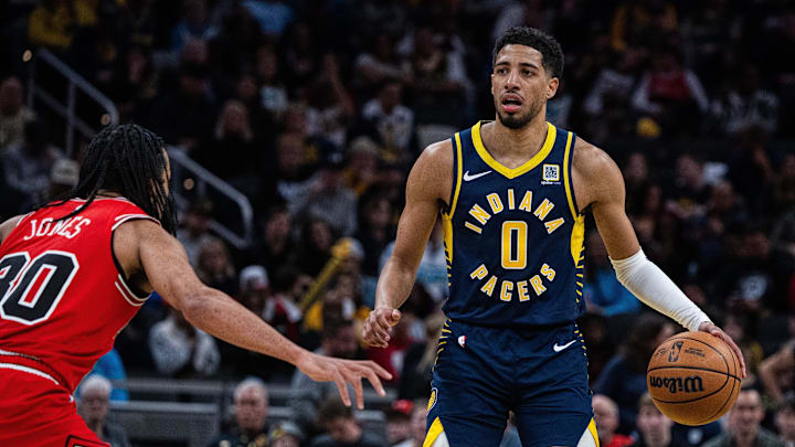Mar 2, 2025; Indianapolis, Indiana, USA; Indiana Pacers guard Tyrese Haliburton (0) dribbles the ball while Chicago Bulls guard Tre Jones (30) defends in the second half  at Gainbridge Fieldhouse. Mandatory Credit: Trevor Ruszkowski-Imagn Images