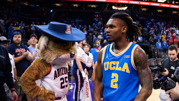 Dec 14, 2024; Phoenix, Arizona, USA; UCLA Bruins guard Dylan Andrews (2) celebrates as he walks past Arizona Wildcats mascot Wilbur following the game at Footprint Center. Mandatory Credit: Mark J. Rebilas-Imagn Images