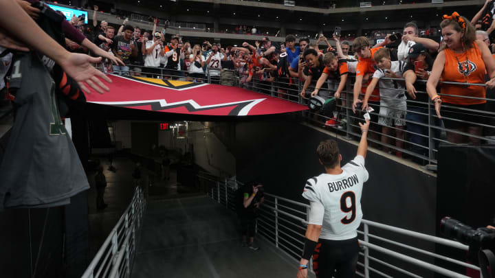 Oct 8, 2023; Glendale, Arizona, USA; Cincinnati Bengals quarterback Joe Burrow (9) high-fives fans after their win over the Arizona Cardinals at State Farm Stadium. Mandatory Credit: Joe Rondone-USA TODAY Sports