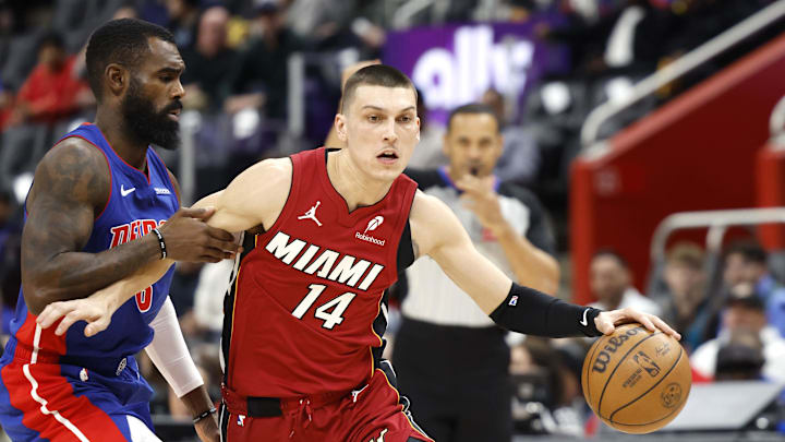 Dec 16, 2024; Detroit, Michigan, USA;  Miami Heat guard Tyler Herro (14) dribbles while being defended by Detroit Pistons forward Tim Hardaway Jr. (8) in the first half at Little Caesars Arena. Mandatory Credit: Rick Osentoski-Imagn Images