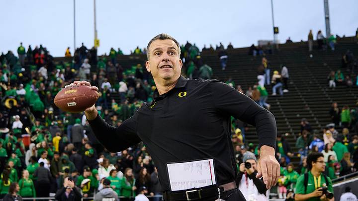 Nov 27, 2021; Eugene, Oregon, USA; Oregon Ducks head coach Mario Cristobal throws a football to his son’s after a game against the Oregon State Beavers at Autzen Stadium. The Ducks won 38-29. Mandatory Credit: Troy Wayrynen-USA TODAY Sports