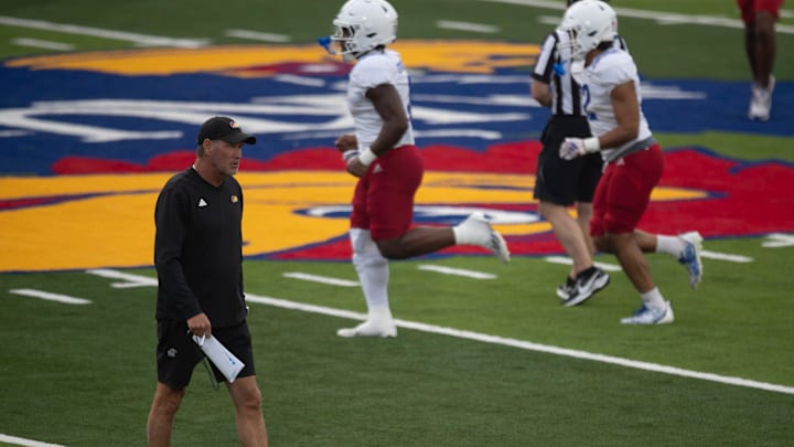 Kansas head coach Lance Leipold walks down the 40-yard line as his players hold their first practice inside David Booth Kansas Memorial Stadium on Aug. 1, 2025.
