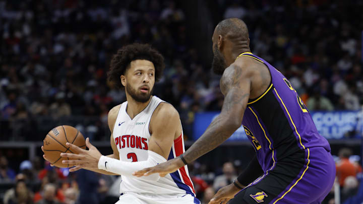 Nov 4, 2024; Detroit, Michigan, USA;  Detroit Pistons guard Cade Cunningham (2) is defended by Los Angeles Lakers forward LeBron James (23) in the second half at Little Caesars Arena. Mandatory Credit: Rick Osentoski-Imagn Images