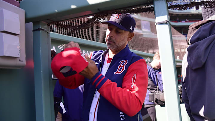 Apr 20, 2026; Boston, Massachusetts, USA;  Boston Red Sox manager Alex Cora signs a hat for a fan prior to a game against the Detroit Tigers at Fenway Park. Mandatory Credit: Bob DeChiara-Imagn Images