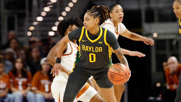 Dec 14, 2025; Fort Worth, Texas, USA; Baylor Bears guard Taliah Scott (0) controls the ball against Texas Longhorns guard Rori Harmon (3) during the first half at Dickies Arena. Mandatory Credit: Chris Jones-Imagn Images