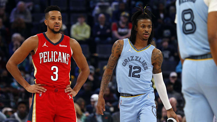 Mar 8, 2022; Memphis, Tennessee, USA; New Orleans Pelicans guard CJ McCollum (3) and Memphis Grizzlies guard Ja Morant (12) wait for play to resume during the first half at FedExForum. Mandatory Credit: Petre Thomas-Imagn Images