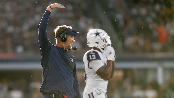 Dallas Cowboys head coach Brian Schottenheimer looks on during the against the Washington Commanders at AT&T Stadium. Dallas Cowboys head coach Brian Schottenheimer looks on during the against the Washington Commanders at AT&T Stadium.