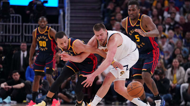 Apr 4, 2025; San Francisco, California, USA;  Golden State Warriors guard Stephen Curry (30) and Denver Nuggets center Nikola Jokic (15) chase the ball in the third period at Chase Center. Mandatory Credit: David Gonzales-Imagn Images