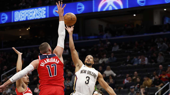 Jan 5, 2025; Washington, District of Columbia, USA; New Orleans Pelicans guard CJ McCollum (3) shoots the ball as Washington Wizards center Jonas Valanciunas (17) defends in the fourth quarter at Capital One Arena. Mandatory Credit: Geoff Burke-Imagn Images