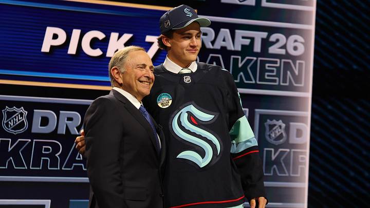 Jun 26, 2026; Buffalo, New York, USA; Chase Reid reacts beside NHL commissioner Gary Bettman after being selected with the seventh pick in the first round of the 2026 NHL Draft by the Seattle Kraken at KeyBank Center. Mandatory Credit: Timothy T. Ludwig-Imagn Images