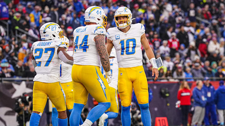 Dec 28, 2024; Foxborough, Massachusetts, USA; Los Angeles Chargers quarterback Justin Herbert (10) reacts after running back J.K. Dobbins (27) scores against the New England Patriots in the second half at Gillette Stadium. Mandatory Credit: David Butler II-Imagn Images