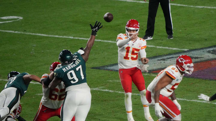 Chiefs quarterback Patrick Mahomes looks for an opening in the defense as Eagles lineman Javon Hargrave gets in his face during Super Bowl 57.