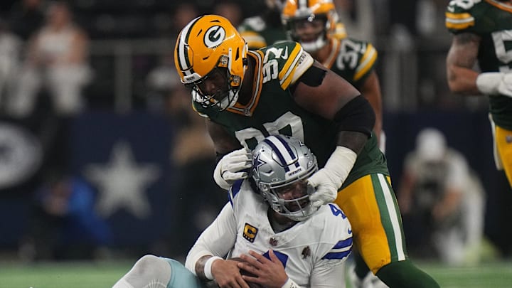 Green Bay Packers defensive tackle Kenny Clark (97) is called for a facemask penalty while tackling Dallas Cowboys quarterback Dak Prescott (4) during the third quarter of the wild card playoff game Sunday, January 14, 2024 at AT&T Stadium in Arlington, Texas.