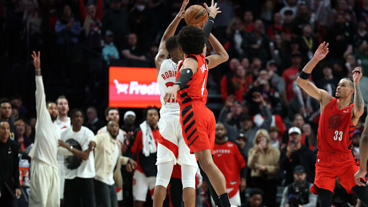 Mar 16, 2025; Portland, Oregon, USA;  Portland Trail Blazers guard Matisse Thybulle (4) makes a game-tying block on Toronto Raptors center Orlando Robinson (21) in the second half at Moda Center. Mandatory Credit: Jaime Valdez-Imagn Images