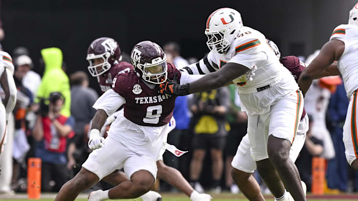 Dec 20, 2025; College Station, TX, USA; Texas A&M Aggies defensive end Cashius Howell (9) rushes the line past Miami Hurricanes offensive lineman Markel Bell (70) during the game between the Aggies and the Hurricanes at Kyle Field. Mandatory Credit: Jerome Miron-Imagn Images