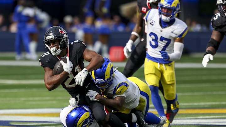 Los Angeles Rams safety Kam Curl (3) and Los Angeles Rams linebacker Omar Speights (48) tackle Houston Texans running back Nick Chubb (21) during the fourth quarter at SoFi Stadium. 