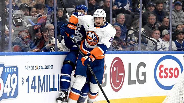 Sep 30, 2026; Toronto, Ontario, CAN;  New York Islanders defenseman Alexander Romanov (28) bodychecks Toronto Maple Leafs defenseman Darren Raddysh (43) in the first period at Scotiabank Arena.  Mandatory Credit: Dan Hamilton-Imagn Images