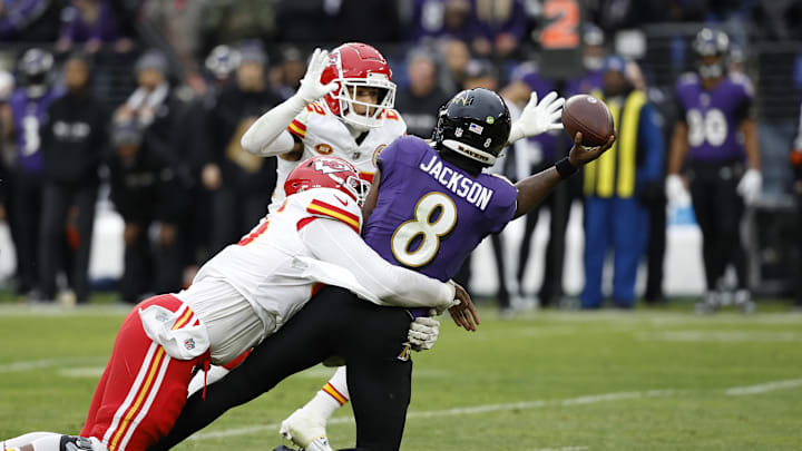 Jan 28, 2024; Baltimore, Maryland, USA; Baltimore Ravens quarterback Lamar Jackson (8) throws the ball around Kansas City Chiefs cornerback Trent McDuffie (22) while being sacked by Chiefs defensive tackle Chris Jones (95) during the first half in the AFC Championship football game at M&T Bank Stadium. Mandatory Credit: Geoff Burke-USA TODAY Sports