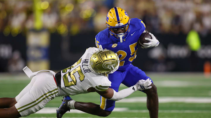 Nov 22, 2025; Atlanta, Georgia, USA; Pittsburgh Panthers running back Ja'Kyrian Turner (25) is tackled by Georgia Tech Yellow Jackets defensive back Kelvin Hill (16) in the first quarter at Bobby Dodd Stadium at Hyundai Field. Mandatory Credit: Brett Davis-Imagn Images Nov 22, 2025; Atlanta, Georgia, USA; Pittsburgh Panthers running back Ja'Kyrian Turner (25) is tackled by Georgia Tech Yellow Jackets defensive back Kelvin Hill (16) in the first quarter at Bobby Dodd Stadium at Hyundai Field. Mandatory Credit: Brett Davis-Imagn Images