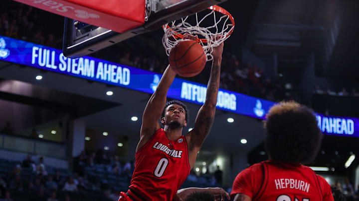 Feb 1, 2025; Atlanta, Georgia, USA; Louisville Cardinals forward James Scott (0) dunks over Georgia Tech Yellow Jackets forward Ibrahim Souare (30) in the first half at McCamish Pavilion. 