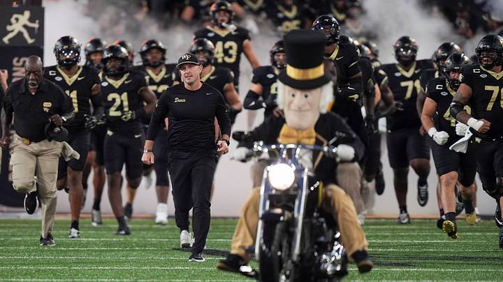 Sep 18, 2026; Winston-Salem, North Carolina, USA;  Wake Forest Demon Deacons head coach Jake Dickert leads his team onto the field against the Miami (FL) Hurricanes during the first half at Allegacy Federal Credit Union Stadium.  Mandatory Credit: Jim Dedmon-Imagn Images