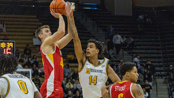 Nov 9, 2025; Columbia, Missouri, USA; VMI forward TJ Johnson attempts a three-point shot over Missouri forward Jevon Porter (14) at Mizzou Arena. 