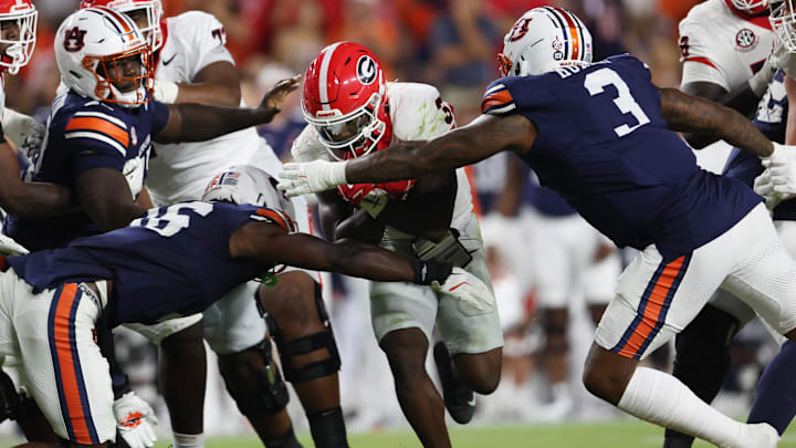 Oct 11, 2025; Auburn, Alabama, USA;  Auburn Tigers linebacker Bryce Deas (16) and defensive end Chris Murray (3) close in on Georgia Bulldogs running back Nate Frazier (3) during the third quarter at Jordan-Hare Stadium. Mandatory Credit: John Reed-Imagn Images