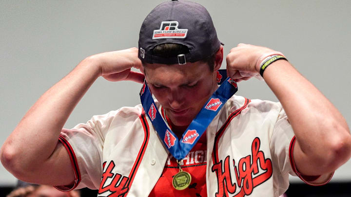 Iowa City High’s Parker Sutherland puts on his state championship medal during a celebration of his team’s success July 26, 2025 in Iowa City.