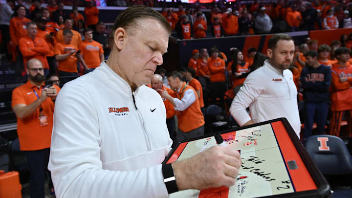 Feb 4, 2026; Champaign, Illinois, USA;  Illinois Fighting Illini head coach Brad Underwood prepares his game plan before tip-off against the Northwestern Wildcats at State Farm Center. Mandatory Credit: Ron Johnson-Imagn Images