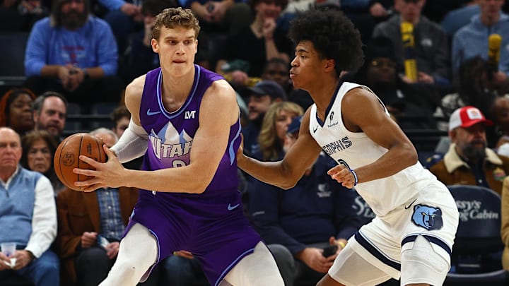 Jan 25, 2025; Memphis, Tennessee, USA; Utah Jazz forward Lauri Markkanen (23) controls the ball against Memphis Grizzlies forward Jaylen Wells (0) during the first quarter at FedExForum. Mandatory Credit: Petre Thomas-Imagn Images